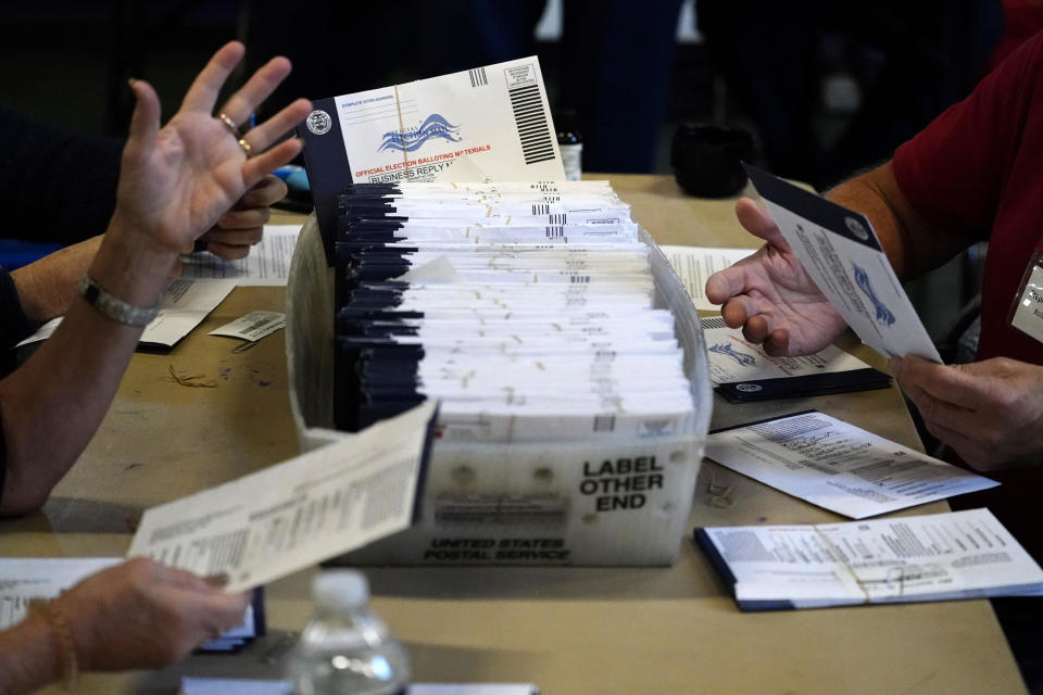 In this November 4, 2020, file photo, Chester County election workers process mail-in and absentee ballots for the 2020 general election in the United States at West Chester University in West Chester, Pennsylvania. / Credit: Matt Slocum / AP