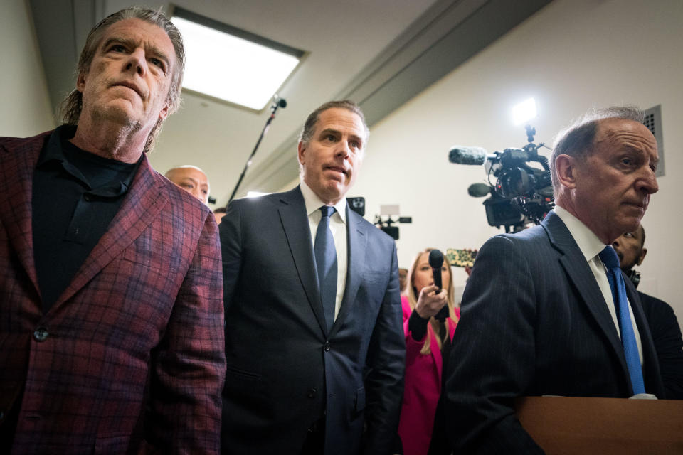 Hunter Biden, center, flanked by Kevin Morris, left, and attorney Abbe Lowell, right, departs a House Oversight Committee meeting on Jan, 10, 2024. / Credit: Kent Nishimura / Getty Images