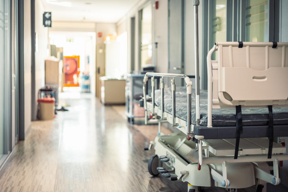 Empty hospital beds in hospital corridor