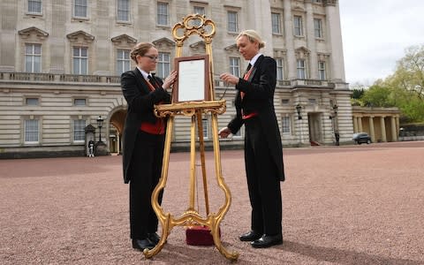 A notice is placed on an easel in the forecourt of Buckingham Palace  - Credit: Stefan Rousseau /PA