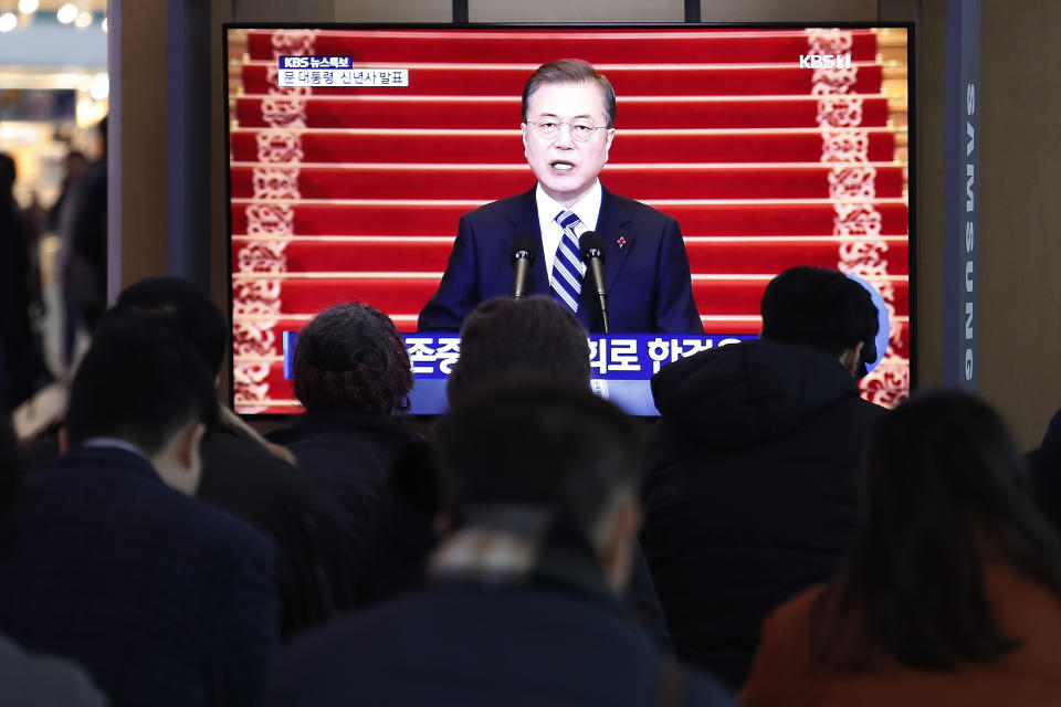 People watch a TV screen showing the live broadcast of South Korean President Moon Jae-in's New Year's speech at the Seoul Railway Station in Seoul, South Korea, Tuesday, Jan. 7, 2020. Moon said he hopes to see North Korean leader Kim Jong Un fulfill a promise to visit the South this year as he called for the rival Koreas to end a prolonged freeze in bilateral relations. (AP Photo/Ahn Young-joon)