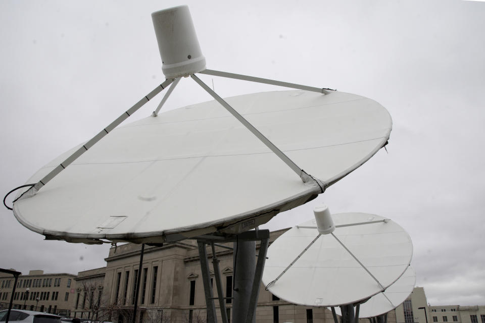 In this Nov. 21, 2019 photo, satellite dishes are seen on the property of KETV, an ABC-affiliated television station in Omaha, Neb. An estimated 500,000 households nationwide don't have access to local broadcast channels because of a complicated federal law and a decades-long dispute between local broadcasters and satellite television providers. Households in the nation's "neglected markets" _ rural areas that can't get local broadcast signals, are forced to rely on satellite service with news from other states. (AP Photo/Nati Harnik)