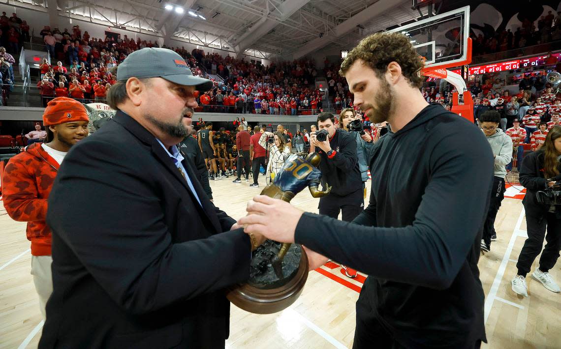 N.C. State linebacker Payton Wilson gets the Butkus Award from Matt Butkus, son of legendary NFL linebacker Dick Butkus, the award’s namesake during the Wolfpack’s basketball game against Maryland Eastern Shore at Reynolds Coliseum Wednesday, Dec. 6, 2023. Ethan Hyman/ehyman@newsobserver.com