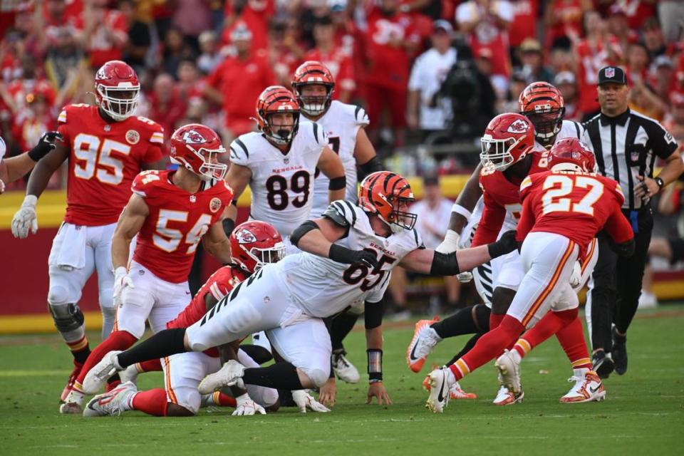 Kansas City Chiefs safety Chamarri Conner (27) evades the grasp of Cincinnati Bengals guard Alex Cappa (65) and heads to the end zone for a touchdown after picking up a fumble by Cincinnati Bengals quarterback Joe Burrow in the second half Sunday, Sept. 15, 2024, at GEHA Field at Arrowhead Stadium.