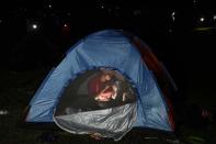 Una migrante desayuna dentro de su tienda de campaña el miércoles 15 de septiembre de 2021, en un campamento en Acandí, Colombia. (AP Foto/Fernando Vergara)