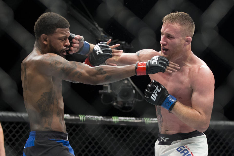 FILE - In this July 7, 2017, file photo, Michael Johnson, left, is hit by Justin Gaethje in a UFC lightweight mixed martial arts bout in Las Vegas. Gaethje and Tony Ferguson will headline the mixed martial arts card at UFC 249 behind closed doors at Veterans Memorial Arena in Jacksonville, Fla., Saturday, May 9, 2020. UFC 249 will serve as the first major sporting event to take place since the coronavirus pandemic shut down much of the country nearly two months ago. (Erik Verduzco/Las Vegas Review-Journal via AP)