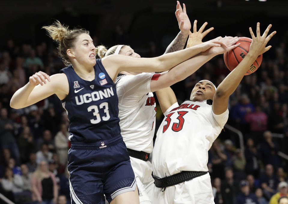 Connecticut guard Katie Lou Samuelson (33) knocks the ball from Louisville forward Sam Fuehring, center, and Louisville forward Bionca Dunham (33)  during the first half of a regional championship final in the NCAA women's college basketball tournament, Sunday, March 31, 2019, in Albany, N.Y. (AP Photo/Kathy Willens)