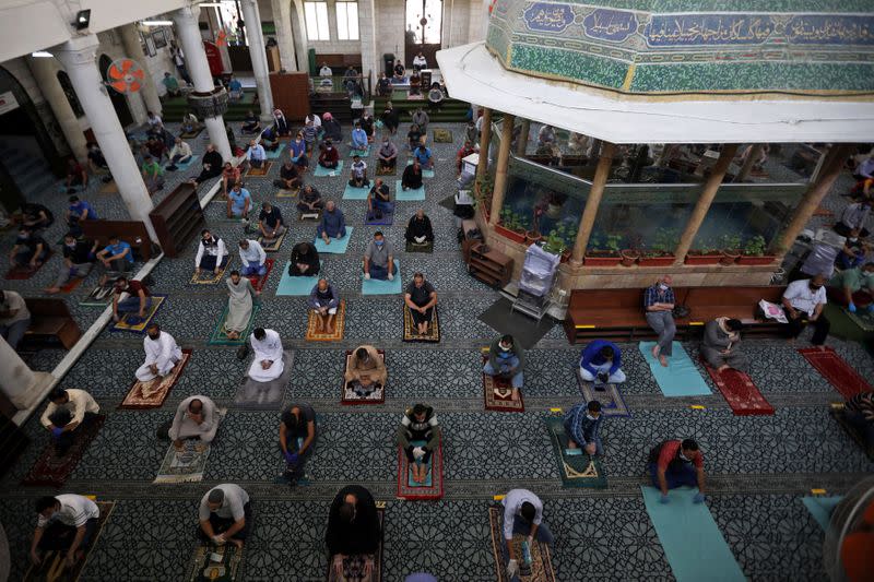 Muslims attend Friday prayers at al Husseini mosque in Amman