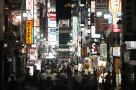 People crowd the street in the Kabukicho area, Tokyo's entertainment district, Friday, July 16, 2021, in Tokyo. Tokyo is under a fourth state of emergency, which began Monday and requires restaurants and bars to close early and not serve alcohol through the 2020 Summer Olympics, which start July 23. (AP Photo/Jae C. Hong)