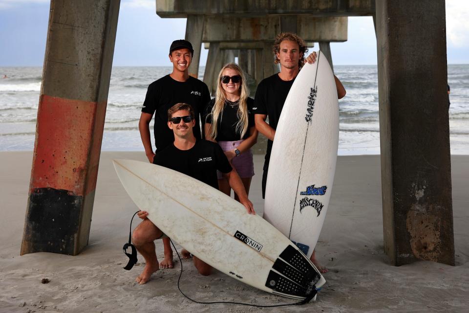 The UNF surf team is shown in portrait, from bottom left clockwise, C.J. Rogers, Cameron Alvarez, Sophie Falzone, and team captain Charlie Current Thursday, June 9, 2022 at Jacksonville Beach. They are winners of the East Coast Championships earlier this spring and travel to the National Scholastic Surfing Association championships in Dana Point, Calif. UNF is attempting to become the first East Coast team to win the national championships. Because of COVID-19, this is UNF's first appearance at nationals since 2019. 
