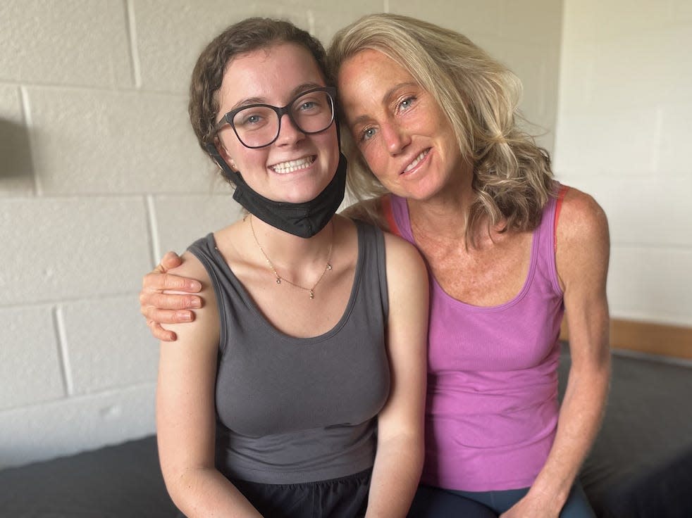 Amy McHugh (right) and her daughter, Isabelle (left) sitting on a college bed