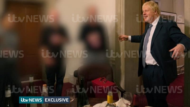 A handout picture shows British Prime Minister Boris Johnson raising a glass during a party at Downing Street, amid the coronavirus disease (COVID-19) pandemic in London