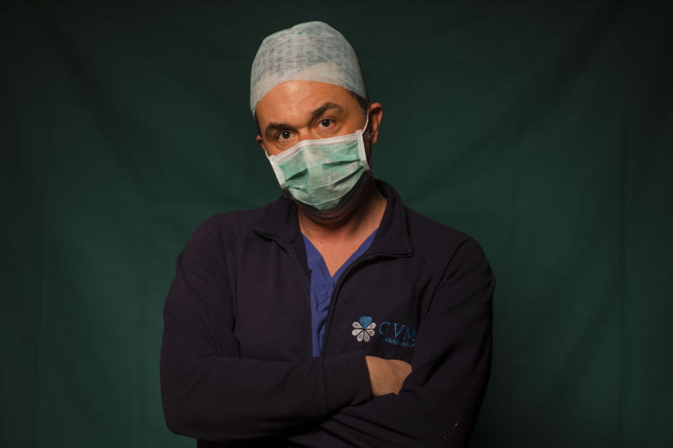 Mirko Perruzza, 43, a nurse at Rome's COVID 3 Spoke Casalpalocco Clinic, poses for a portrait, Friday, March 27, 2020, during a break in his daily shift. Their eyes are tired. Their cheekbones are rubbed raw from protective masks. They don't smile. The intensive care doctors and nurses on the front lines of the coronavirus pandemic in Italy are often almost unrecognizable behind their masks, scrubs, gloves and hairnets their only barrier to contagion. (AP Photo/Domenico Stinellis)