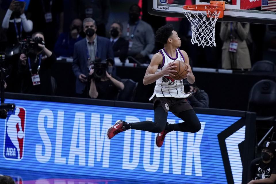 Trail Blazers guard Anfernee Simons dons a Tracy McGrady jersey as he competes in the slam dunk contest.