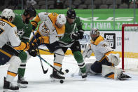 Nashville Predators defenseman Mattias Ekholm (14) and goaltender Pekka Rinne (35) defend the goal against Dallas Stars left wing Jamie Benn (14) and center Joe Pavelski (16) in the second period during an NHL hockey game on Sunday, March 7, 2021, in Dallas. (AP Photo/Richard W. Rodriguez)