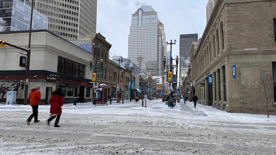 People trudge across a snowy intersection in the city's downtown on Jan. 10. 