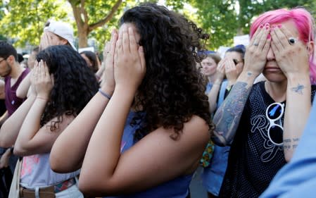 Families of victims and activists attend a rally against "femicide", gender-based violence targeted at women, in Paris