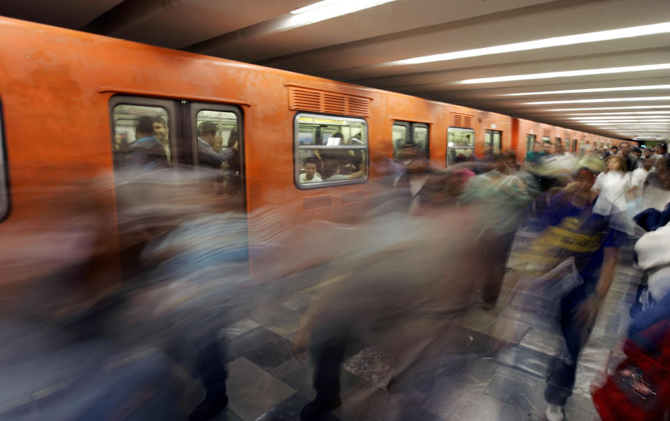 Commuters come and go inside Hidalgo subway station 10 October, 2007 in Mexico City. The subway service of the overpopulated Mexican capital presently transports 4,3 million commuters a day, one million less than 15 years ago, PRI's local deputy and former subway union leader Fernando Espino said to AFP.     AFP PHOTO/Ronaldo SCHEMIDT (Photo credit should read Ronaldo Schemidt/AFP/Getty Images)