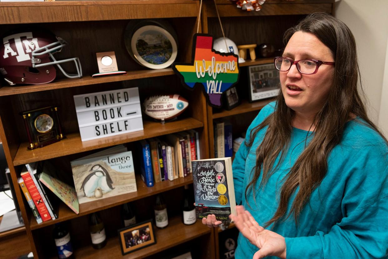 State Rep. Erin Zwiener, D-Driftwood, discusses the banned books on a bookshelf in her Capitol office. The bookshelf holds books that have been banned or yanked from school libraries around the state.