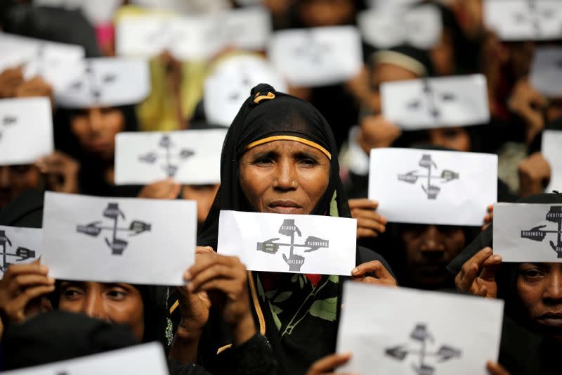 FILE PHOTO: Rohingya refugee women hold placards as they take part in a protest at the Kutupalong refugee camp to mark the one-year anniversary of their exodus in Cox's Bazar