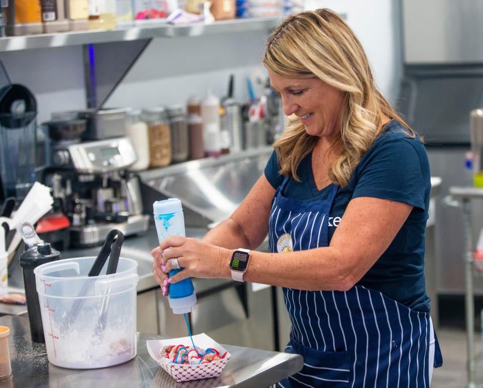 Rosemary Leonard makes a doughnut specialty Monday, June 27, 2022, at Diamond Dough and Co. in Cassopolis.