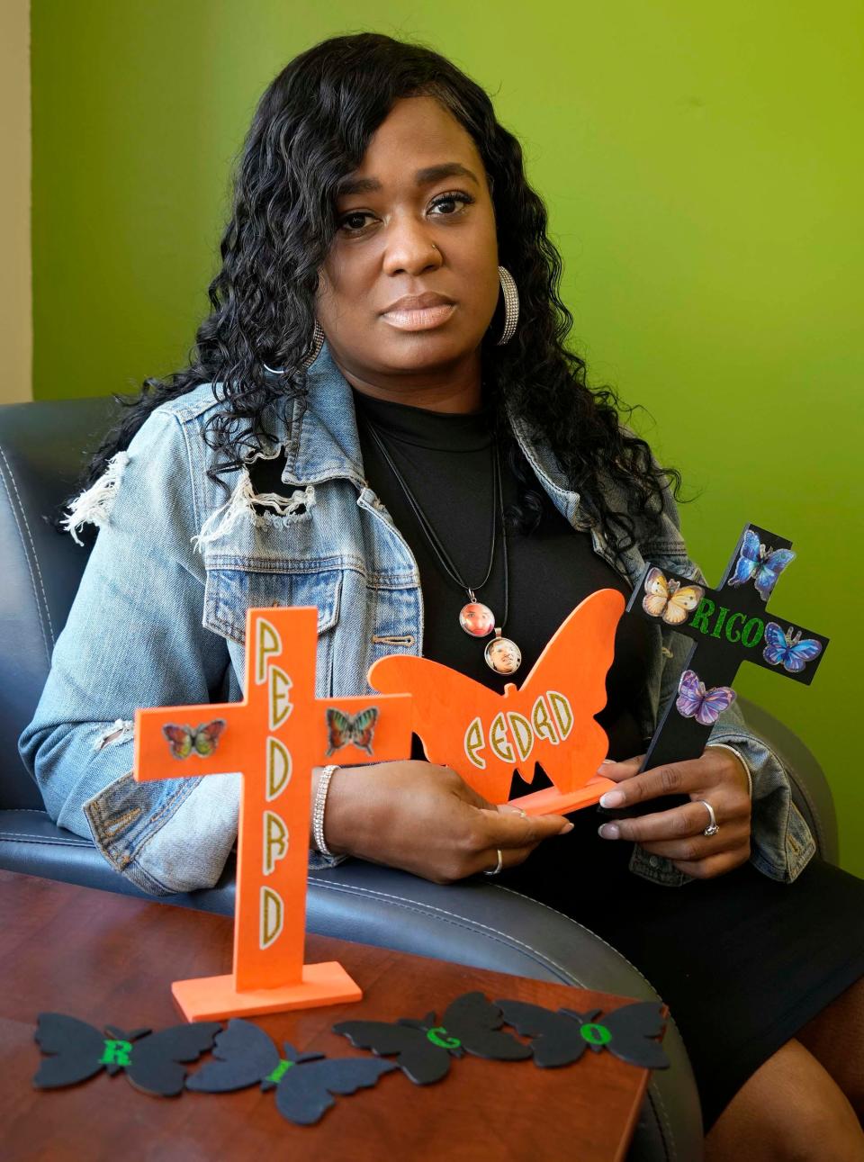 Dee-Dee Davis, close to two homicide victims who died in the last couple years, holds two butterfly sets, gifted to her by Shequila Morrison, at Community Advocates where she works on North James Lovell Street in Milwaukee on Friday, July 7, 2023. The sets were made in memorial of her God children Pedro Milan, who died in April of 2020 and Jose “Rico” Stanton, who died in Dec. 2021, both victims of gun violence.