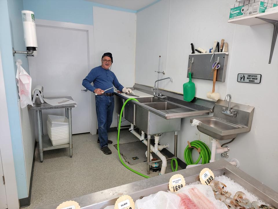 Business owner Luis Delgado cleaning fish at his Blue Ocean Fish Market at 764 N. 9th Street in Stroudsburg