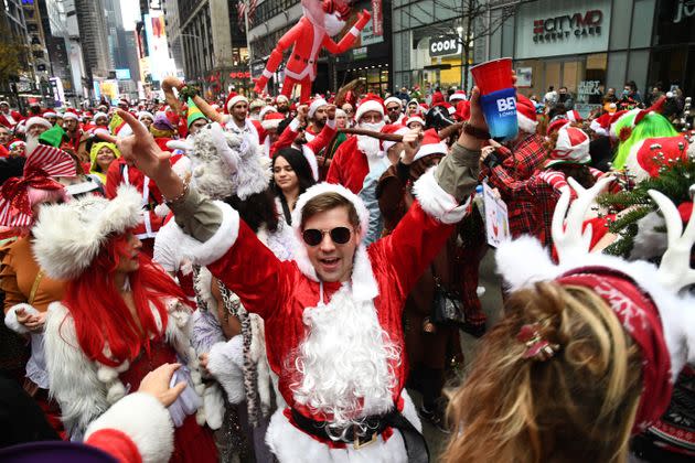 Partiers dressed up for SantaCon on Dec. 11. The annual event (which was canceled last year) is thought to be one of the reasons for the recent COVID surge in New York City. (Photo: Kevin Mazur via Getty Images)