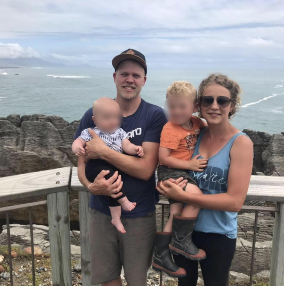 The New Zealand mum (far right) with her husband and their two children at a lookout over a beach.