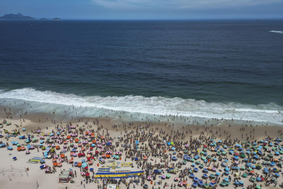 Argentine Boca Juniors fans gather on Copacabana beach the day before their team faces Brazil's Fluminense at the Copa Libertadores championship match in Rio de Janeiro, Brazil, Friday, Nov. 3, 2023. (AP Photo/Bruna Prado)