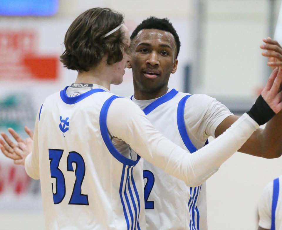 CVCA sophomore Darryn Peterson (right) is congratulated by teammate Max Winslow after he scored his 1,000 career point, Tuesday, Feb. 14, 2023, against Northwest.