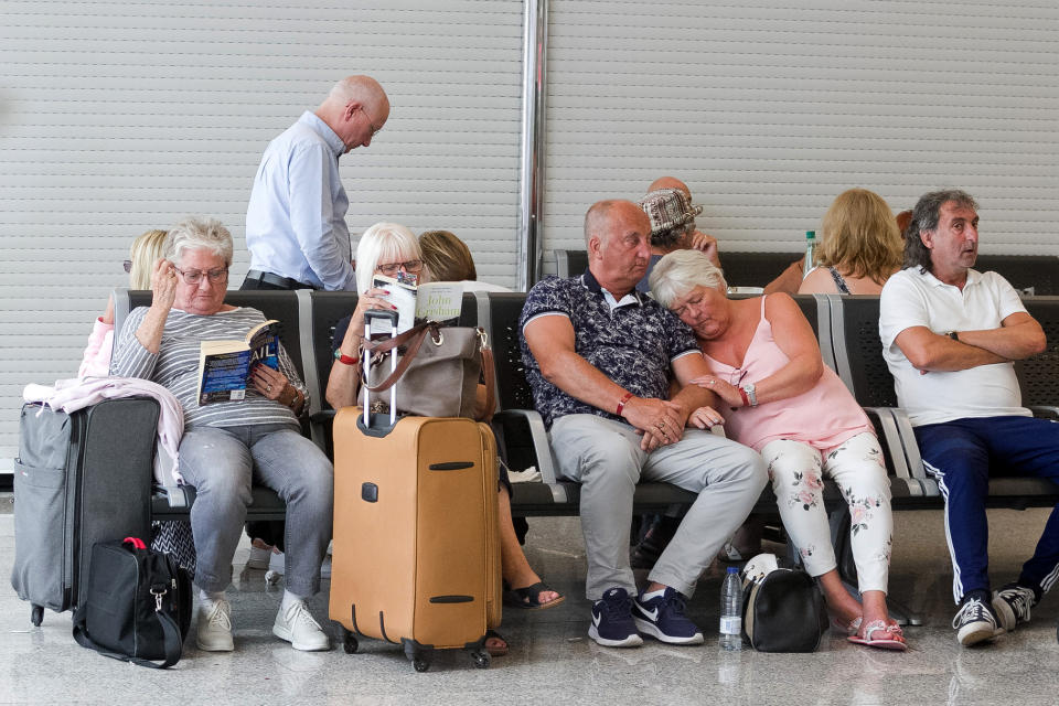 British passengers wait for news on cancelled Thomas Cook flights at Palma de Mallorca airport on Monday, Sept. 23, 2019. Spain's airport operator AENA says that 46 flights have been affected by the collapse of the British tour company Thomas Cook, mostly in the Spanish Balearic and Canary archipelagos. (AP Photo/Francisco Ubilla)