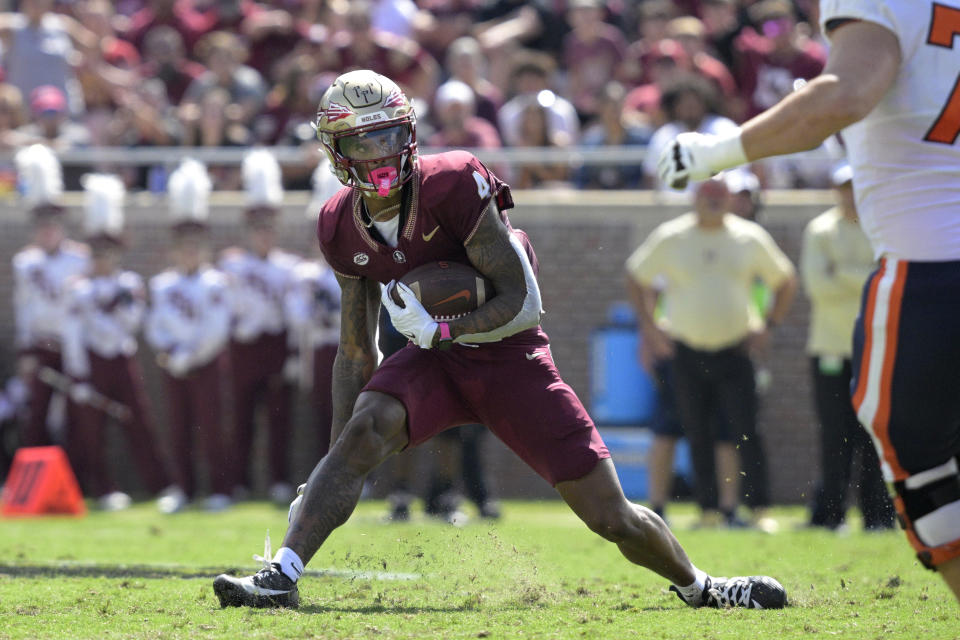 FILE - Florida State's Keon Coleman (4) runs on a punt return against Syracuse during the first half of an NCAA college football game Oct. 14, 2023, in Tallahassee, Fla. The Buffalo Bills elected not to trade back in the NFL draft order for a third time, and addressed their most significant need by selecting receiver Keon Coleman to open the second round Friday, April 26, 2024. (AP Photo/Phelan M. Ebenhack, File)