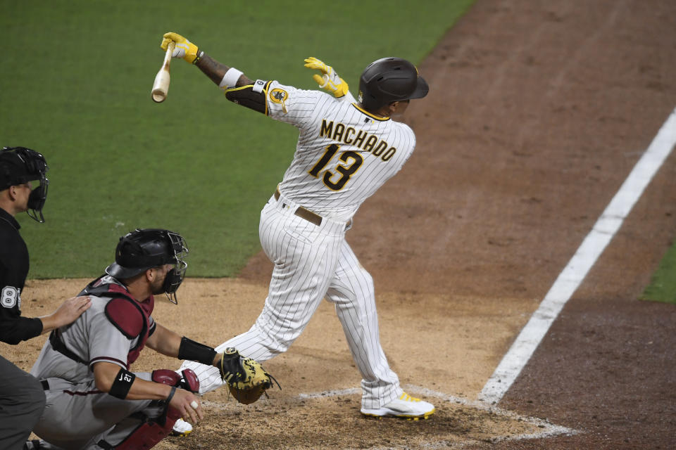 San Diego Padres' Manny Machado follows through on a single during the sixth inning of the team's baseball game against the Arizona Diamondbacks on Saturday, April 3, 2021, in San Diego. (AP Photo/Denis Poroy)