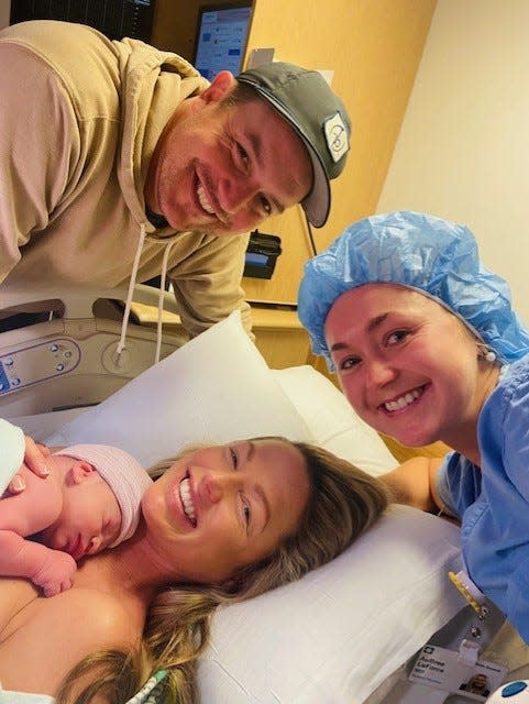 TNT NBA sideline reporter Allie LaForce, holding her newborn son, Jacob Michael Smith, is pictured with her husband, MLB veteran pitcher Joe Smith and her sister, Dr. AuBree LaForce, who delivered the couple's child at Cleveland Clinic Akron General.