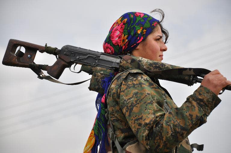 A Kurdish female fighter of the Women's Protection Units (YPJ) looks on at a training camp in al-Qahtaniyah, near the Syrian-Turkish border on February 13, 2015