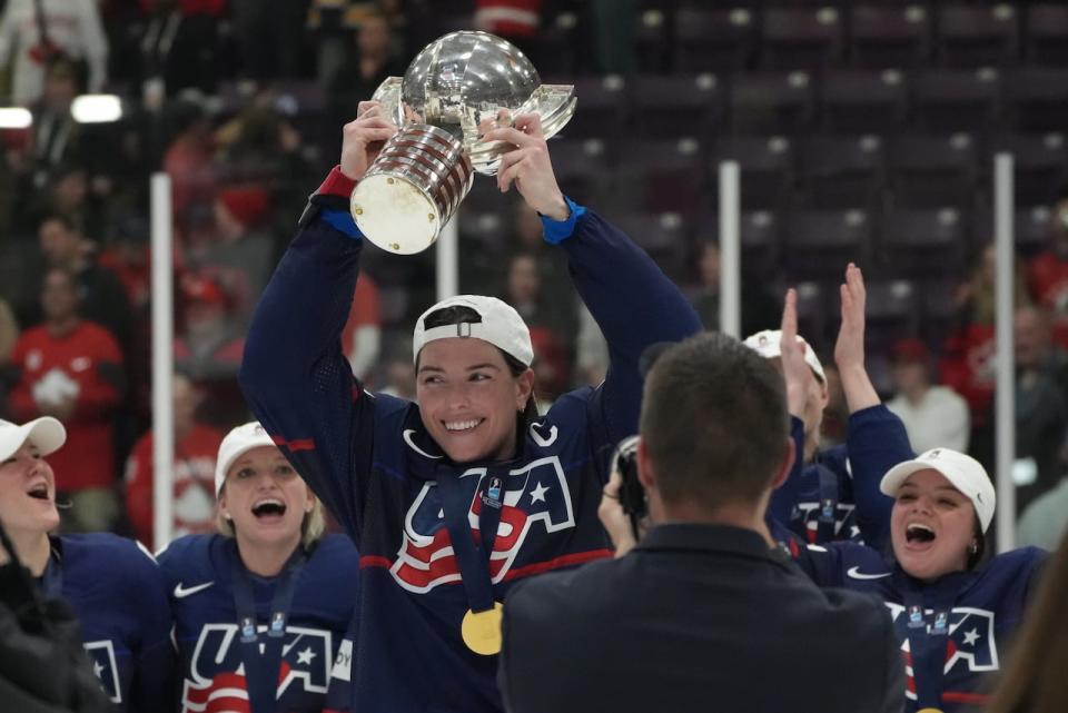 U.S. forward Hilary Knight, centre, celebrates the women's world championship trophy with teammates against Canada on April 16, 2023 in Brampton, Ont. (Nathan Denette/The Canadian Press - image credit)