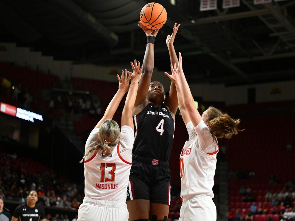 Aliyah Boston shoots over two Maryland defenders.