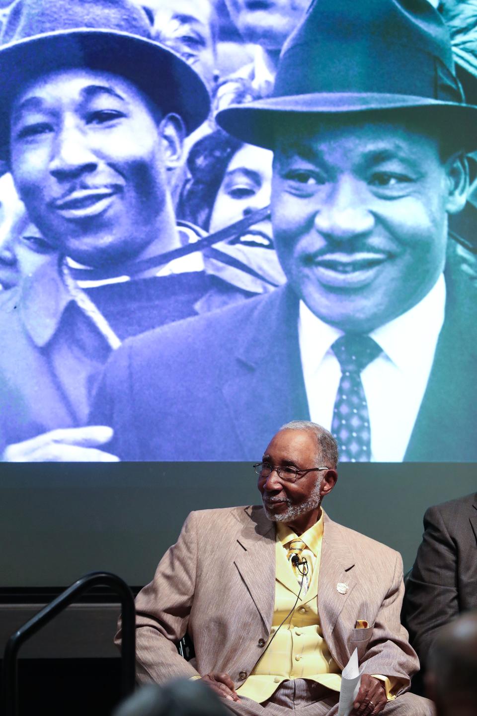 The Rev. Louis Newby spoke about his recollections of the 1964 March on Frankfort during a discussion as part of the Frazier History Museum's Bridging the Divide Series in Louisville, Ky. on Feb. 22, 2024. He was sitting beneath a photo of himself, on the left, with Martin Luther King Jr. who was one of the speakers at the march.