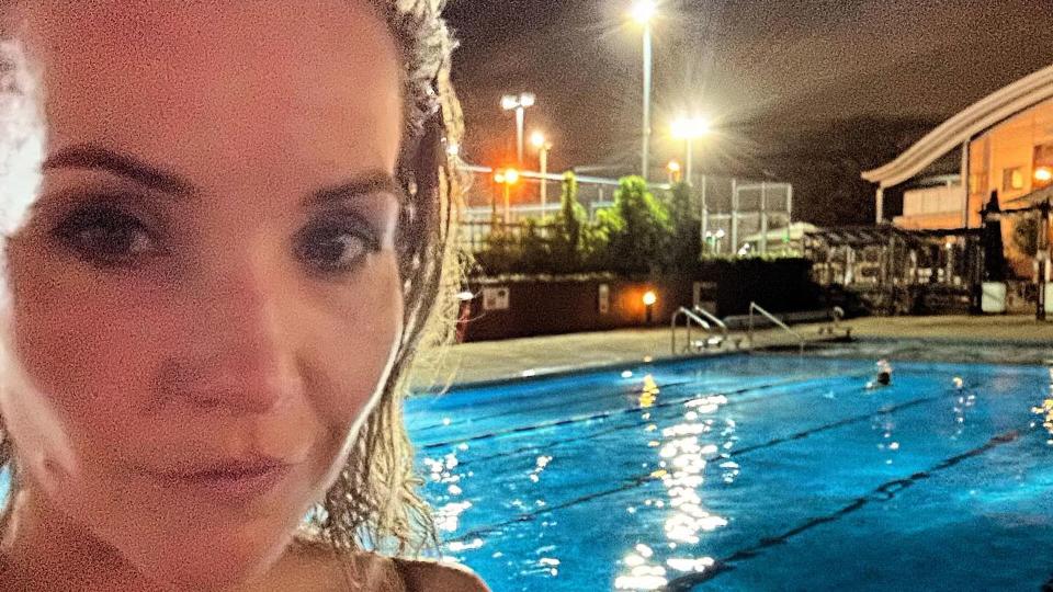 Helen Skelton posing beside a swimming pool