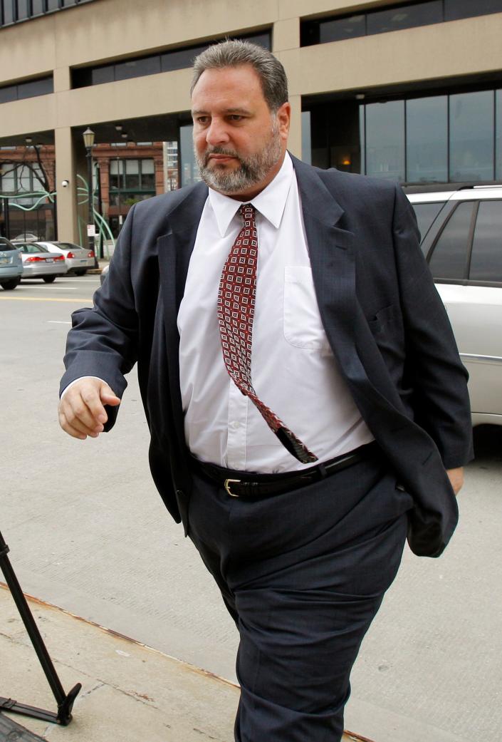 In this Oct. 26, 2011 file photo, former Cuyahoga County commissioner Jimmy Dimora arrives at a federal courthouse in Cleveland. In 2009, following a massive public corruption case, voters approved government reforms.