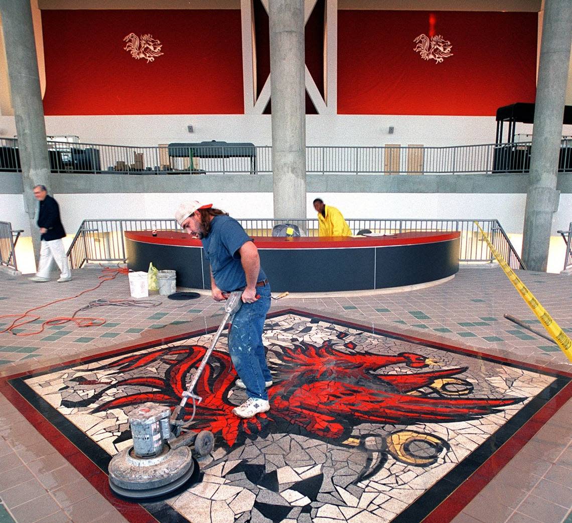 The precast terrazzo tile gamecock is polished in 2002 in the new Carolina Center lobby.