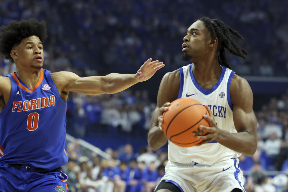 Kentucky's Antonio Reeves, right, looks for a shot while defended by Florida's Zyon Pullin (0) during the first half of an NCAA college basketball game Wednesday, Jan. 31, 2024, in Lexington, Ky. (AP Photo/James Crisp)