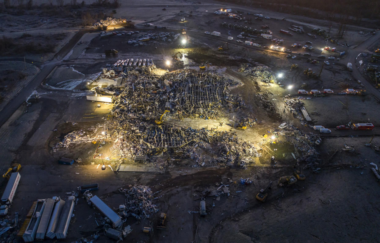 Image: Search and rescue crews work at the leveled Mayfield Consumer Products candle factory after a tornado caused catastrophic damage in Mayfield, Ky., on Dec. 12, 2021. (Ryan C. Hermens / Lexington Herald-Leader via AP)