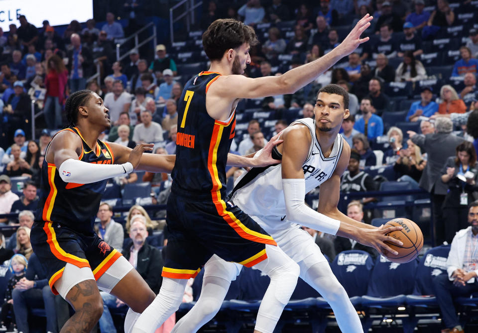 Oklahoma City rookie Chet Holmgren defends a pass by San Antonio rookie Victor Wembanyama during their first regular-season game at Paycom Center in Oklahoma City, on Nov. 14, 2023. (Alonzo Adams/USA TODAY Sports)