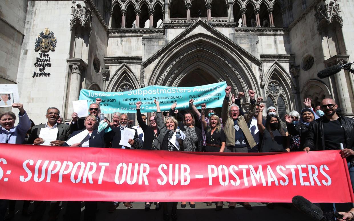 former post office workers celebrating outside the Royal Courts of Justice, London, after their convictions were overturned by the Court of Appeal