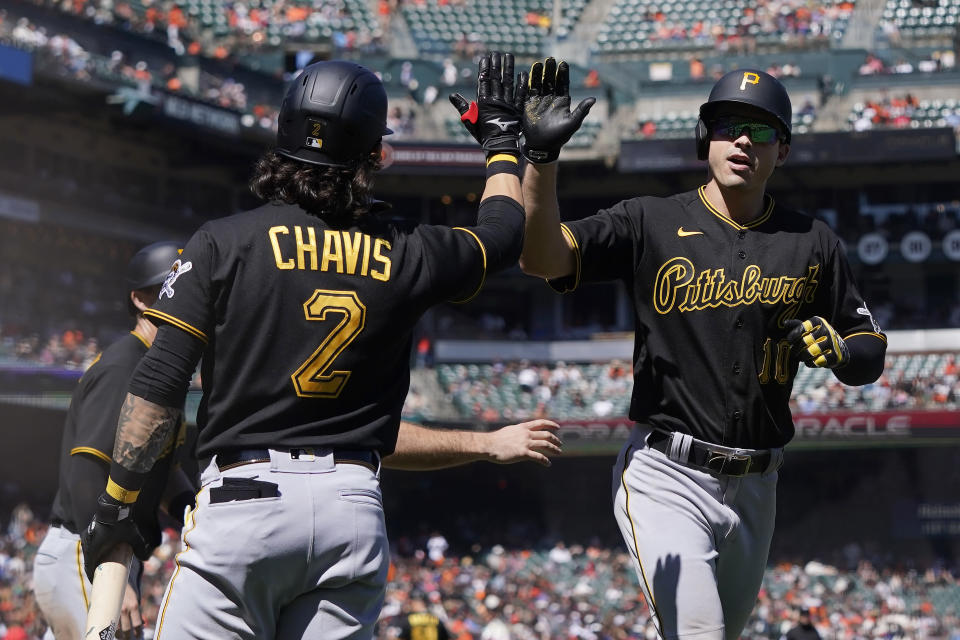 Pittsburgh Pirates' Bryan Reynolds, right, is congratulated by Michael Chavis (2) after hitting a three-run home run that scored Jason Delay and Kevin Newman during the seventh inning of a baseball game against the San Francisco Giants in San Francisco, Sunday, Aug. 14, 2022. (AP Photo/Jeff Chiu)