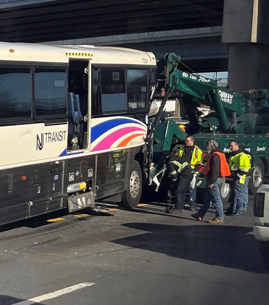 NJ Transit bus is being prepped to be towed after a crash  occurred at mile post 99.4 on the New Jersey Turnpike heading northbound near Interchange 13 on Tuesday, Feb. 14, 2023.