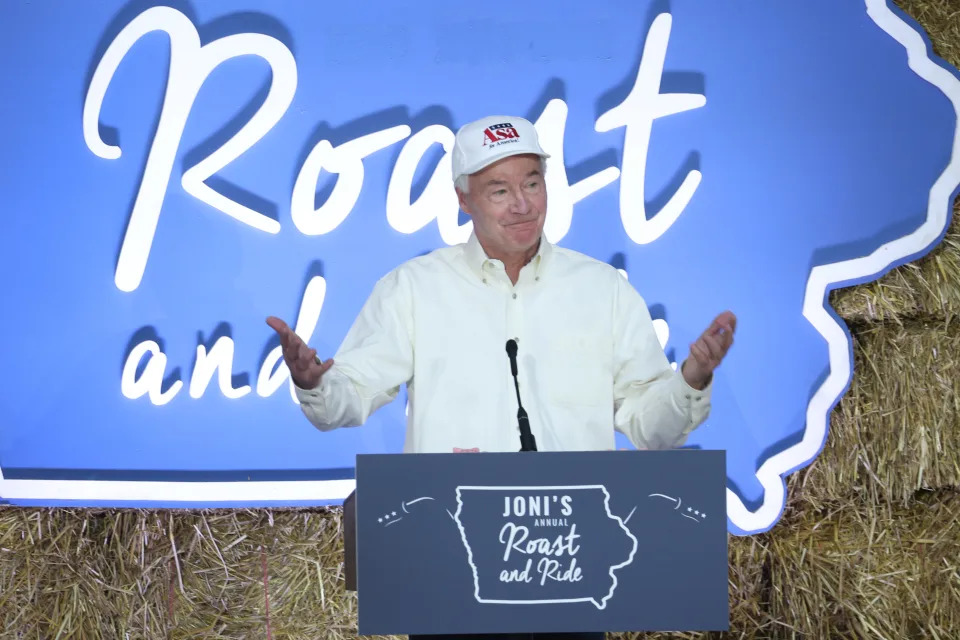 Asa Hutchinson stands at a podium that reads: Joni&#39;s annual Roast and Ride.