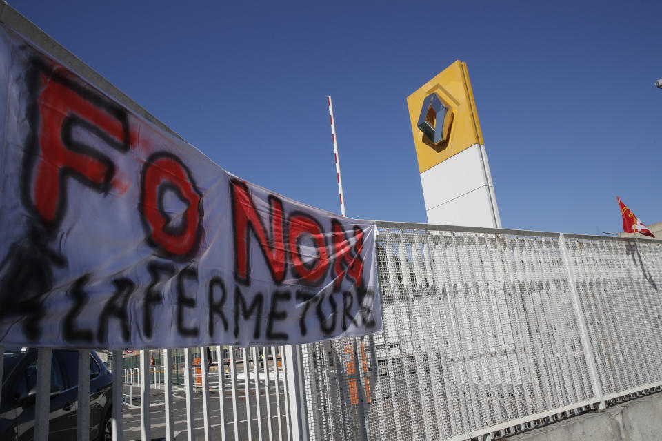 A union banner reading "No to the closure" hangs on the fence of the Renault plant Friday, May 29, 2020 in Choisy-le-Roi, outside Paris. Struggling French carmaker Renault announced 15,000 job cuts worldwide as part of a 2 billion euros cost-cutting plan over three years. The cost-cutting plan comes as Renault came into the virus crisis in particularly bad shape. Its alliance with Nissan and Mitsubishi is a major global auto player but has struggled since the 2018 arrest of its longtime star CEO Carlos Ghosn. (AP Photo/Christophe Ena)